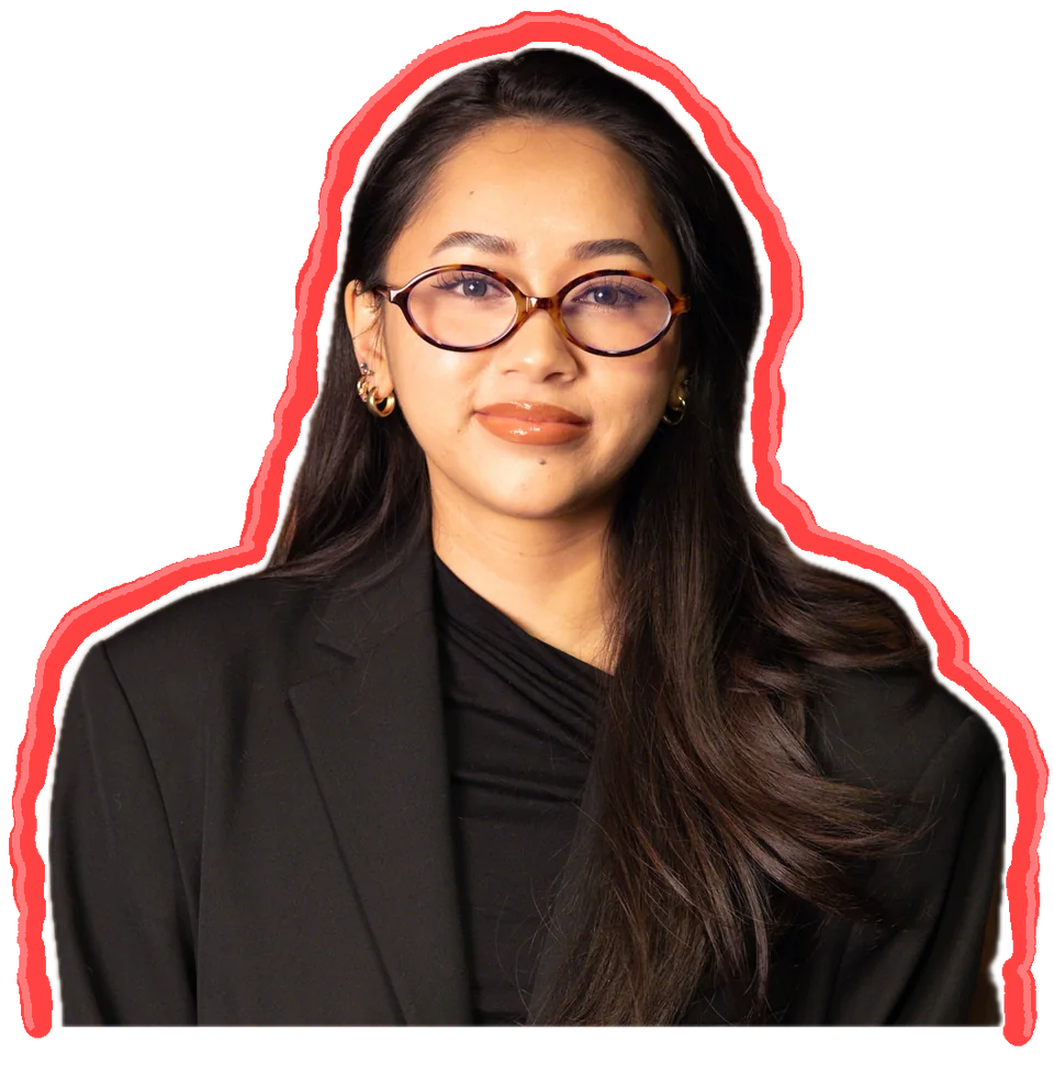 Lannii Tran wearing glasses and a black blazer, outlined in red marker.